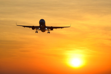 Passenger plane is landing during over take-off at a wonderful sunset. Concept traveling by plane for Background.