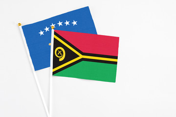 Vanuatu and Kosovo stick flags on white background. High quality fabric, miniature national flag. Peaceful global concept.White floor for copy space.