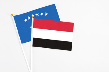 Yemen and Kosovo stick flags on white background. High quality fabric, miniature national flag. Peaceful global concept.White floor for copy space.