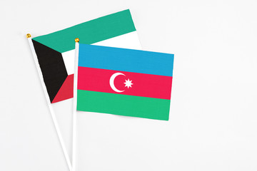 Azerbaijan and Kuwait stick flags on white background. High quality fabric, miniature national flag. Peaceful global concept.White floor for copy space.