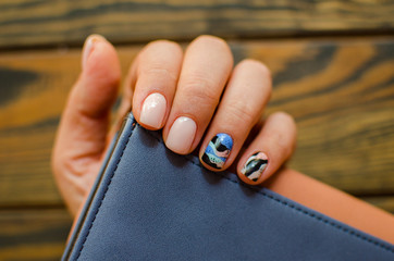 Women's hands with colorful pattern on the nails. Top view. Place for text. cozy winter style.