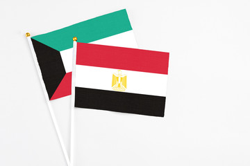 Egypt and Kuwait stick flags on white background. High quality fabric, miniature national flag. Peaceful global concept.White floor for copy space.