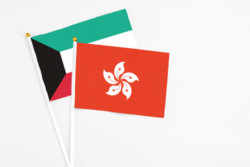 Hong Kong and Kuwait stick flags on white background. High quality fabric, miniature national flag. Peaceful global concept.White floor for copy space.