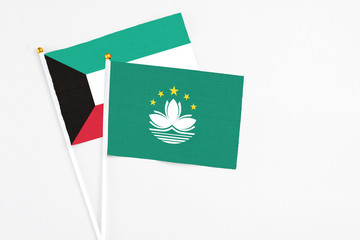 Macao and Kuwait stick flags on white background. High quality fabric, miniature national flag. Peaceful global concept.White floor for copy space.