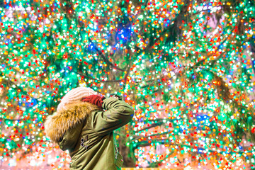 Happy girl on the background of the Rockefeller Christmas tree in New York