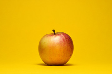organic apple on a yellow background