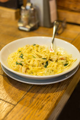 A plate of pasta on the table.