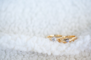 Diamond wedding rings on white soft wool