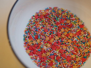 Colorful confectionery powder in a plate, hearts, stars