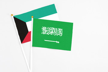 Saudi Arabia and Kuwait stick flags on white background. High quality fabric, miniature national flag. Peaceful global concept.White floor for copy space.