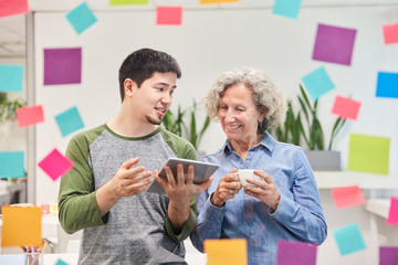 Software developer explains senior woman an app