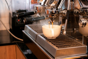 Close-up of espresso pouring from Espresso machine in a cafe