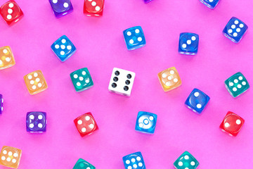 Gambling dices on a pink background.