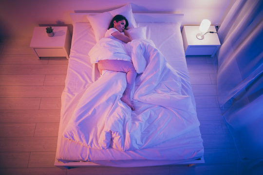 Top above high angle view of her she nice attractive serene calm brunet girl wife lying in bed covered white blanket alone waiting husband at night room house flat house indoors