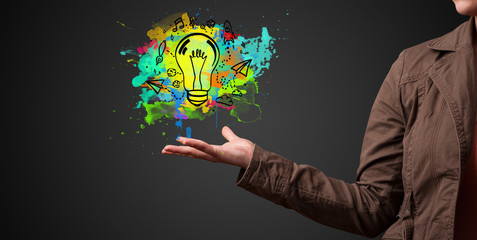 Elegant hand holding lighting bulb in his hand, new idea concept