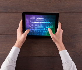 Hand touching tablet with waveforms and sound design concept