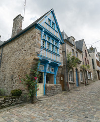 view of the historic half-timbered and stone houses on the Rue du Petit Fort street in old town of Dinan in Brittany