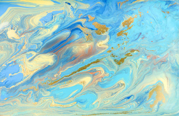 Blue and yellow marble pattern with golden glitter. Abstract liquid background
