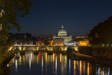 Fototapeta na wymiar Dusk at the Vatican City. St. Peter's basilica in Rome, Vatican, the dome at sunset with reflection. Night view at St. Peter's cathedral in Rome, Italy. Scenic background. Popular travel destination.