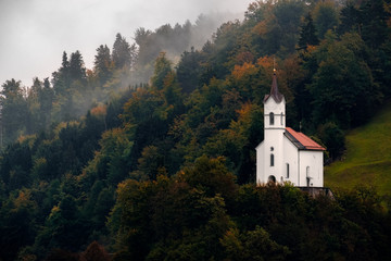 Scenic view of small church on a hill among trees, Slovenia