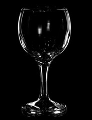 Glass of wine on a black background with glare reflected in it
