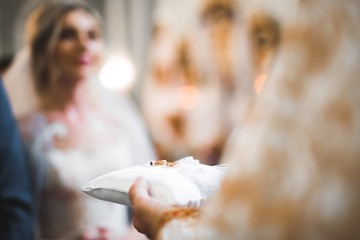 Wedding rings on ceremony at church. Macro.