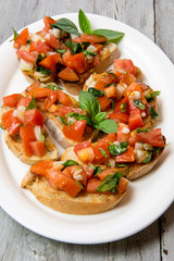 Bruscheta, antipasti Typical Italian with tomato, basil and toast