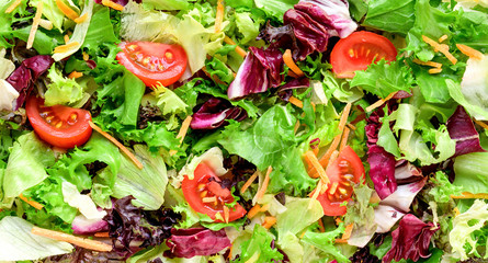 Mixed fresh salad leaves background.