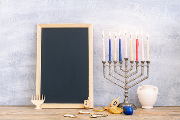 Menorah, dreidels and hanukkah coins with copy space