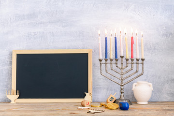 Menorah, dreidels and hanukkah coins with copy space
