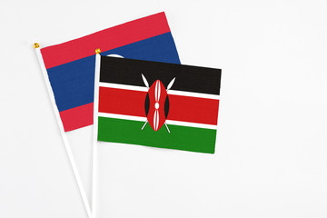 Kenya and Laos stick flags on white background. High quality fabric, miniature national flag. Peaceful global concept.White floor for copy space.