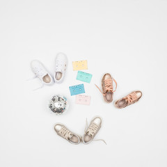 Fashion clothes - sports shoes for women; photo in neutral background.