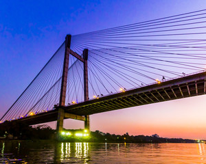 Fototapeta na wymiar Vidyasagar Setu Bridge in Kolkata, set against a sunset sky