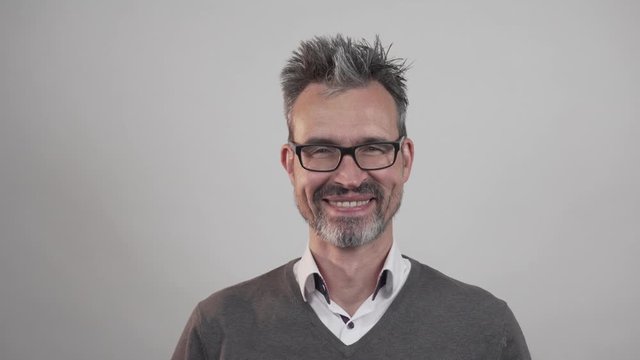 happy mature adult man smiling. cheeful businessman looks into camera while laughing loud