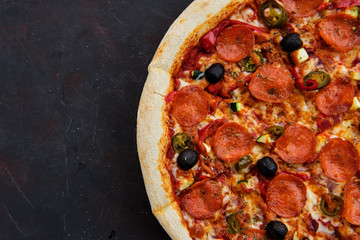 Close up view of pizza sicilian with salami, zucchini, jalapeno and bell pepper