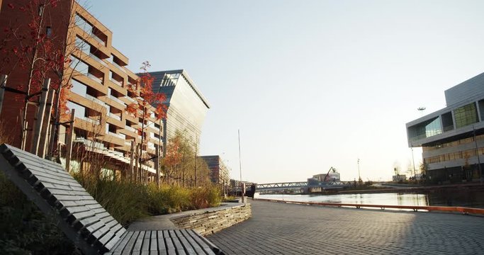 4K static low angle wide shot of Lambda, the new Edvard Munch museum, with famous paintings like The Anxiety, in an autumn sunset in the Bj&oslash;rvika quarter in Oslo, Norway.