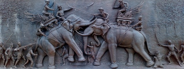 statue in temple,Thai style art carving..Thai art is unique...Fighting a war elephant in ancient times..