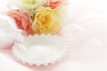Rock salt on white plate with flower for beauty image