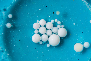 Beautiful colorful background with glitter and colored bubbles in oil and watercolor. Sparkle particles. Macro oil ink bubbles and drops. Abstract template mixed texture. Colored Wallpaper Pattern 