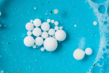 Beautiful colorful background with glitter and colored bubbles in oil and watercolor. Sparkle particles. Macro oil ink bubbles and drops. Abstract template mixed texture. Colored Wallpaper Pattern 