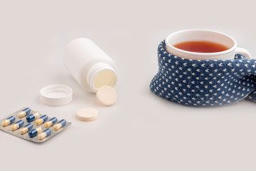 Cup of tea, thermometer, crumpled napkin, medical mask