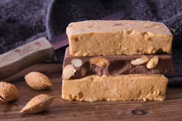 Almond nougat, typical Christmas dessert on wooden background