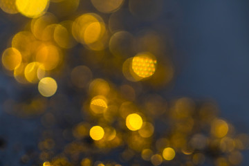 Obraz premium Out of focus gold light particles. Golden dust sparkle. abstract blur With Blinking Bokeh bright party lights Abstract Glitter Defocused abstract background. Golden yellow bokeh lights