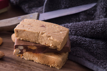 Almond nougat, typical Christmas dessert on wooden background