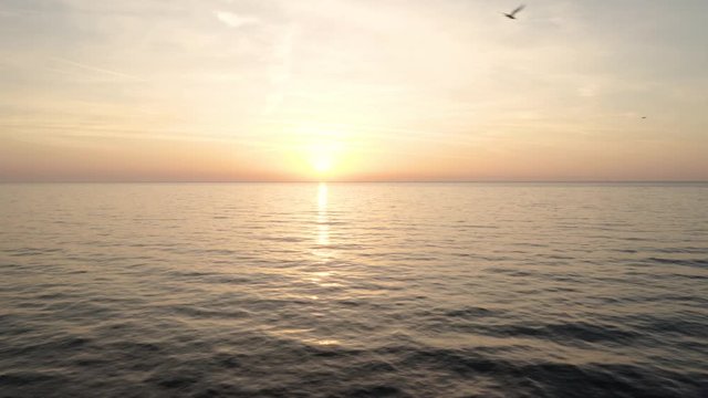 Drone flight with a green wavy sea and beautiful sunrise - the Black sea, Bulgaria