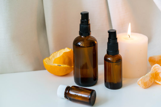 Aromatherapy photo with citrus fruits and peels, essential oils in bottles and aroma candle. Horizontal orientation.