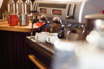 Barista make coffee latte art with espresso machine in cafe.