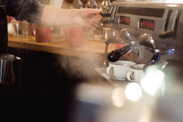 Barista make coffee latte art with espresso machine in cafe.