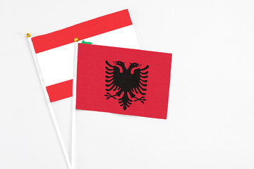 Albania and Lebanon stick flags on white background. High quality fabric, miniature national flag. Peaceful global concept.White floor for copy space.