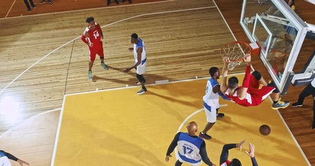 Drone footage of basketball players on big professional arena during the game. Tense moment of the game. Celebration